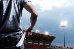 Individual pulling ticket out of pocket in stadium