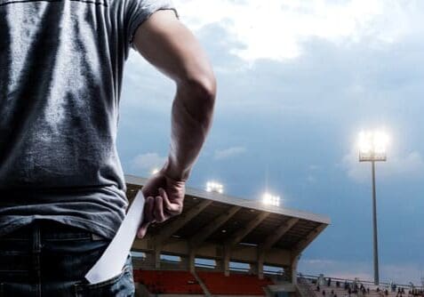 Individual pulling ticket out of pocket in stadium